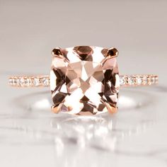 an engagement ring with a cushion cut morganite and diamonds