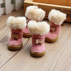 four pairs of pink boots with white fur on the bottom and one has a brown teddy bear