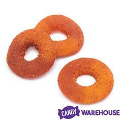 two orange donuts sitting next to each other on a white background with candy warehouse logo