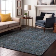 a living room with two couches and a rug on the floor in front of a fireplace