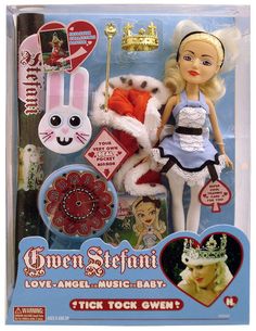 the doll is wearing a tiara and holding a stuffed animal in her hand,