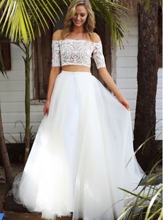 a woman in a white dress standing next to a palm tree with the caption pick an amazing wedding dress for your big day