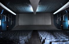 an empty theater with rows of seats