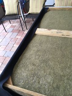 an outdoor area with chairs and rugs on the ground