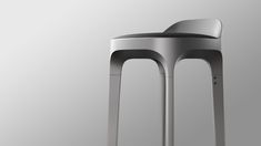 the back side of a metal stool on a gray background