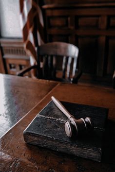 a judge's block on top of a wooden table in a room with chairs