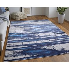 a blue and white area rug in a living room