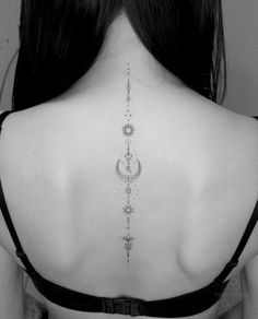 the back of a woman's neck with an intricate design on her lower back