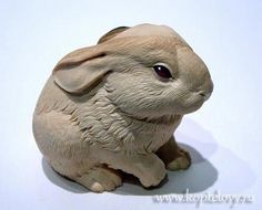 a white rabbit figurine sitting on top of a table