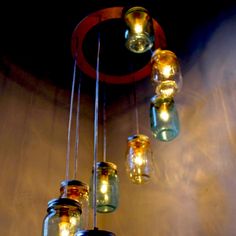 a chandelier made out of mason jars hanging from the ceiling