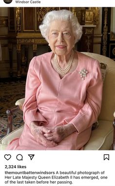 an old woman sitting in a chair with pearls on her hair