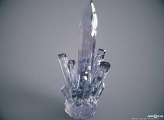 a crystal sculpture with several knives sticking out of it