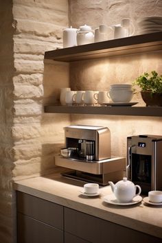 a coffee maker and cups are on the counter