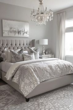 a bedroom with a bed, chandelier and window