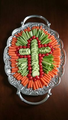 carrots and celery sticks arranged in the shape of a cross