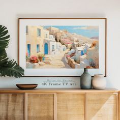 a painting hanging on the wall above a dresser with vases and potted plants