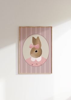 an animal with a pink bow on it's head is mounted to the wall