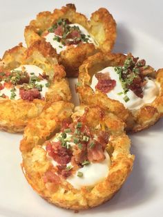 four small appetizers are arranged on a white plate