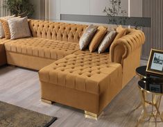 a living room filled with furniture and pillows on top of a wooden floor next to a window