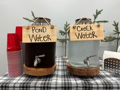 two water dispensers sitting on top of a table