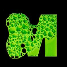 the letter m is made up of green bubbles