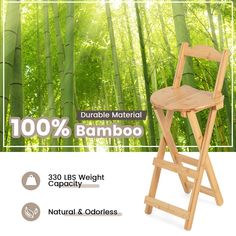 a wooden folding chair in front of bamboo trees with the words 100 % bamboo on it