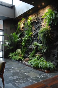 a room filled with lots of plants next to a stone wall