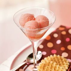 a plate with waffles and ice cream on it next to a pink polka dot napkin