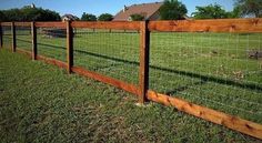 the fence is made of wood and wire