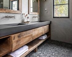 a bathroom with two sinks and mirrors on the wall