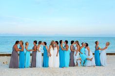 a group of women standing next to each other on a beach