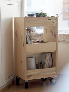 a small wooden cart with books on it