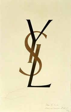 the letter y is inscribed in black and brown on a white paper with gold trim