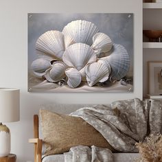 a living room with a couch, lamp and seashells on the wall above it