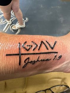 a person's arm with a cross on it and the word jesus written in black ink