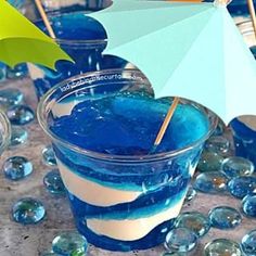 blue liquid in a glass with an umbrella