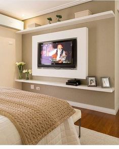 a bedroom with a large flat screen tv mounted to the wall