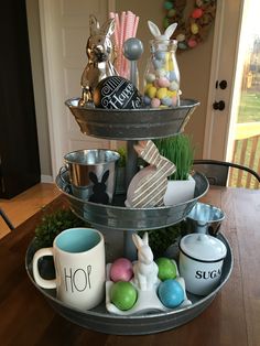 three tiered tray with easter decorations on it