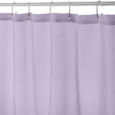 a purple shower curtain hanging on a metal rod