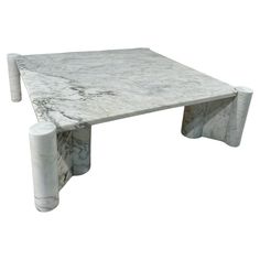 a white marble coffee table with two legs