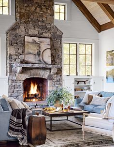 a living room filled with furniture and a fire place in the middle of a room