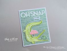 a card with an alligator holding a pink flower