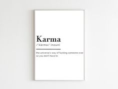 a white poster with the words karma on it in black and white font, against a white wall