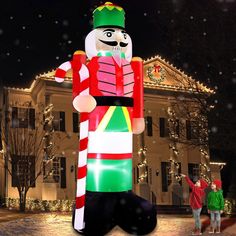 an inflatable nutcracker is on display at the front of a house