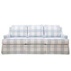 a white and blue checkered couch with pillows on it's back end, in front of a white background