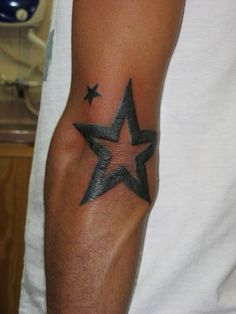 a man with a star tattoo on his arm