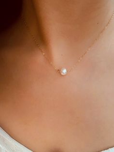 "➤ Spend $80 or above and get a FREE travel size jewellery box packed with your order. *Total transaction excludes shipping. One box per single transaction only. While stock lasts. Promo ends Dec 2023. This Large Solo Pearl Necklace is a unique piece that perfectly embodies elegance and simplicity. Handcrafted with love and precision, this necklace is more than just an accessory - it's a statement. Whether you're attending a wedding or simply dressing up for a day at work, this piece will add a Classic Single Strand Jewelry As A Gift, Classic Single Strand Jewelry Gift, Classic Single Strand Jewelry As Gift, Classic Clavicle Chain Jewelry For Anniversary, Sterling Silver Single Strand Necklace For Wedding, Single Strand Sterling Silver Necklace For Wedding, Sterling Silver Single Strand Jewelry For Gift, Minimalist Birthstone Necklace With Delicate Chain For Formal Occasions, Minimalist Formal Birthstone Necklace With Delicate Chain