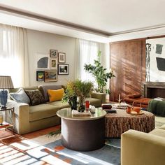 a living room filled with lots of furniture next to a fire place in a fireplace