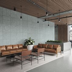 a living room filled with lots of furniture next to a large wall mounted planter