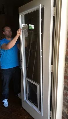 a man is opening the door to his house with an electronic device on it's side